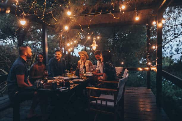 Table d'amis sur une terrasse la nuit l'été